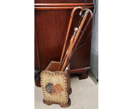 A leather faced stick stand and various silver mounted walking sticks, riding crops etc 
