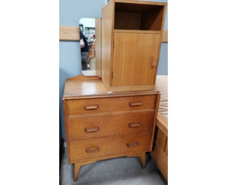 A 1970's G Plan light oak dressing table of 3 drawers; a similar bedside cupboard