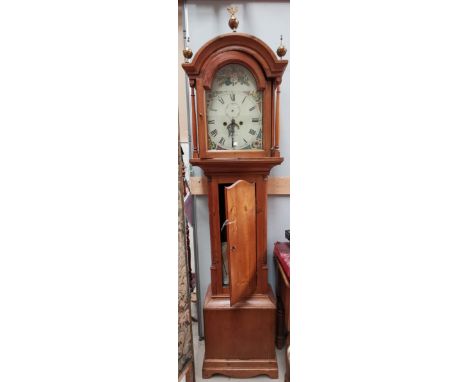 A 19th century longcase clock, the arch top hood with turned pillars and brass finials, quarter reeded columns to the trunk, 