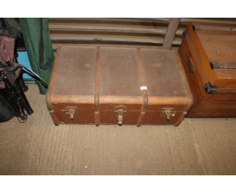 A wooden and metal bound travel trunk