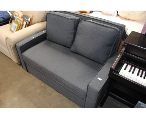 A grey upholstered sofa bed