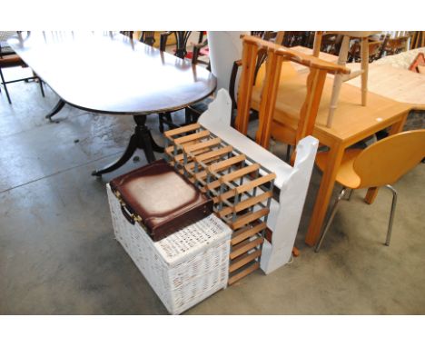 A pine kitchen elbow chair, a pine plate rack, painted hanging bookshelf, a wine rack, a wicker trunk and a briefcase