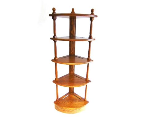 AN ERCOL CORNER SHELF UNIT  in 'Golden Dawn' finish, 35cm deep 126cm high