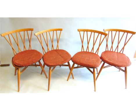 AN ERCOL LIGHT ELM DROP LEAF DINING TABLE,  and a set of four 'Candlestick' or 'Chiltern' Windsor dining chairs