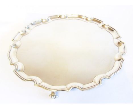 A SILVER SALVER by JB Charterley & Sons Ltd, Birmingham 1970, of circular Chippendale design, on three supports, 40.8cm diame