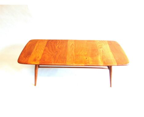 AN ERCOL LIGHT ELM COFFEE TABLE with magazine rack undertier, 46cm deep 104cm long 36.5cm high