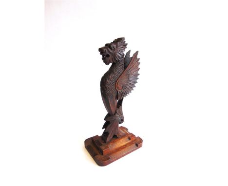 A CARVED WOOD TABLE LAMP IN THE FORM OF A WYVERN first half of the 20th century, on a stepped oak base, 40cm high (lacking fi