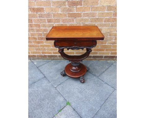A VICTORIAN CARVED MAHOGANY GAMES/WORK TABLE,  the top opening and revolving to chess board inlay, over single drawer and sli