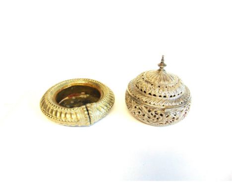 A MIDDLE EASTERN CIRCULAR PIERCED BOX with hinged cover in a silver coloured unmarked metal, 11.5cm diameter; with a Middle E