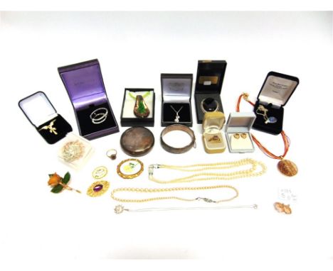 A SILVER TOBACCO BOX of circular outline, with squeeze action, 60g gross; a hinged silver bangle; a 9 carat gold cluster ring