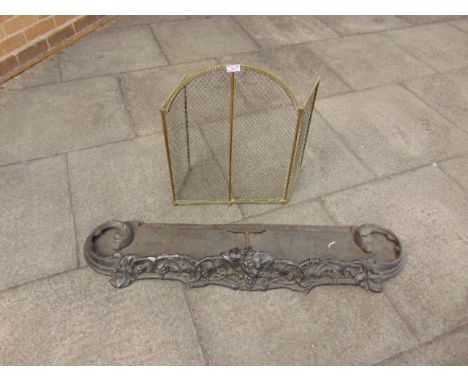 A VICTORIAN CAST IRON FENDER, 114cm wide; together with a brass framed mesh fire screen