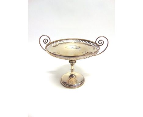 A SILVER COMPORT by Manoah Rhodes & Sons Ltd, London 1921, the pierced edge shallow bowl with two curled handles on a knopped