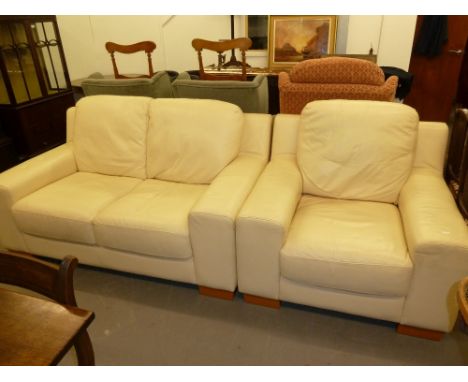 A MODERN CREAM LEATHER TWO SEATER SETTEE AND MATCHING ARMCHAIR (2) 