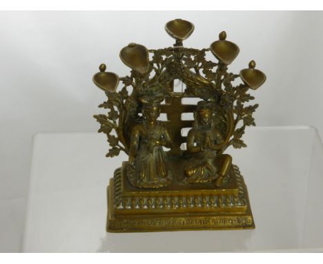 An Antique  brass handle study depicting a Hindu couple in praying position on a square step plinth kneeling in front of a fl