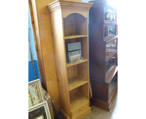 A Pine Book Shelf, the book shelf having four shelves with drawer under, 54 x 35 x 183 cms. 