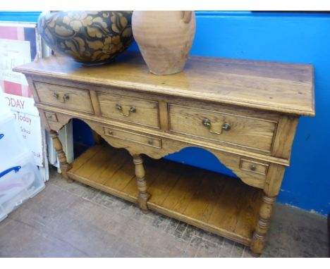 A Cottage Style Pine Dresser, the dresser having three drawers to top with two small and one other to centre. On turned legs 