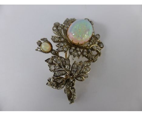 An Antique Opal and Diamond Brooch. The brooch in the form of a flower set with two opals and old cut diamonds.