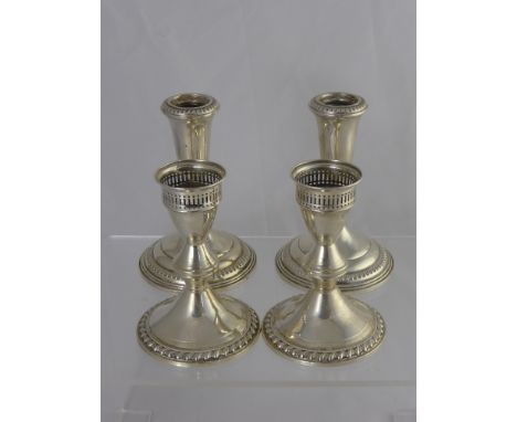 Two American Poole Candle Sticks, together with two others stamped Sterling to base. (4)