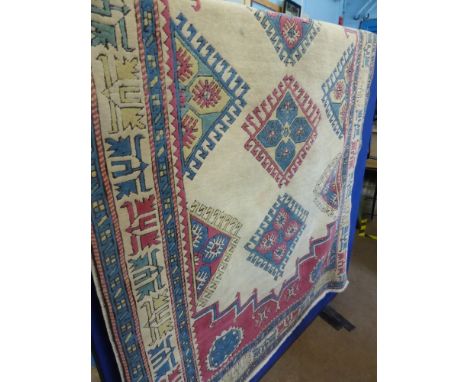A Vintage Turkish Woolen Carpet, with cream ground and central guls, 113 x 200 cms