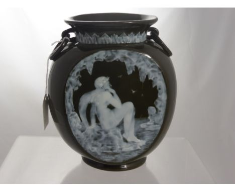 A Victorian Ceramic "Pate sur Pate" green glazed vase. The vase having a white frieze depicting a classical figure beside a l
