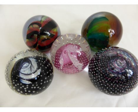 Five Caithness Glass Paper Weights, one entitled "Cauldron" black, "Cauldron" ruby, "Flamenco" pink, "Brush Stroke" mauve and