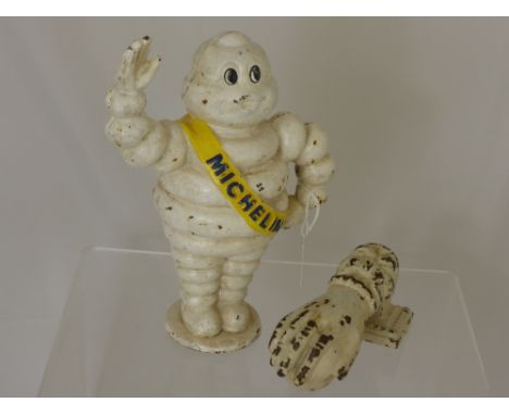 A Cast Iron Michelin Man Piggy Bank, 22 cms high, together with a cast iron door knocker in the form of a hand.