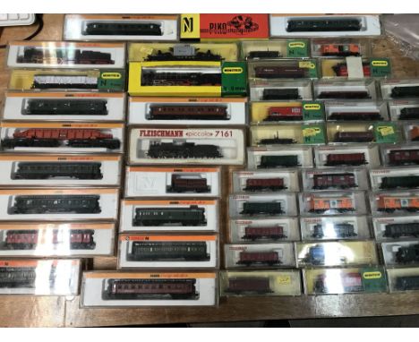 A collection of boxed N gauge railway including, Locomotives, carriages and rolling stock , included are Minitrix, Fleischman