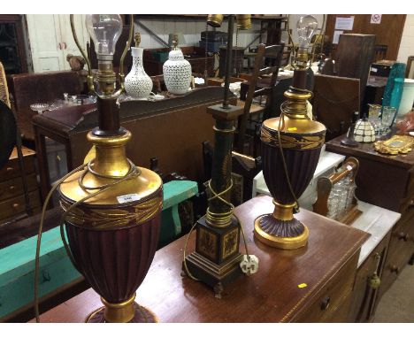 A pair of classical design gilt decorated baluster table lamps and a Toleware style table lamp