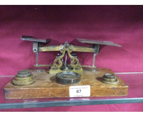 A set of Victorian oak and brass postal scales and weights