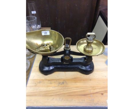A set of brass kitchen scales and weights
