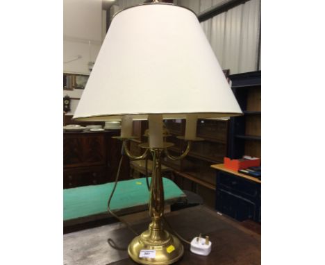 A brass table lamp and shade