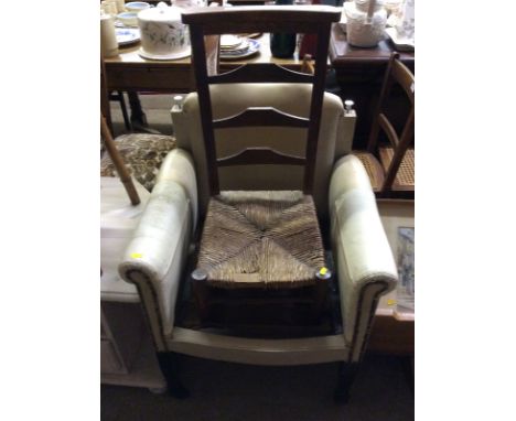 A child's ladder back and rush seated chair; and a leather upholstered chair