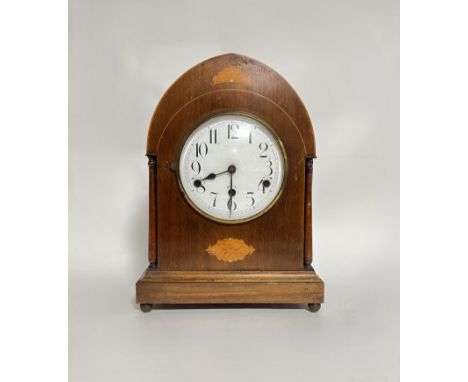 An Edwardian mahogany and inlaid lancet-top table clock with Westminster dial on brass bun feet with marquetry decoration and