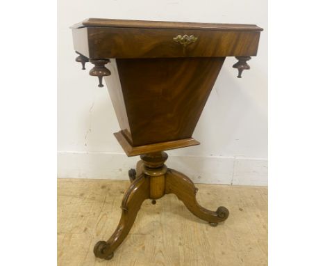 A Victorian mahogany work table, with a rectangular moulded lift up lid revealing a fitted interior, on a turned column with 
