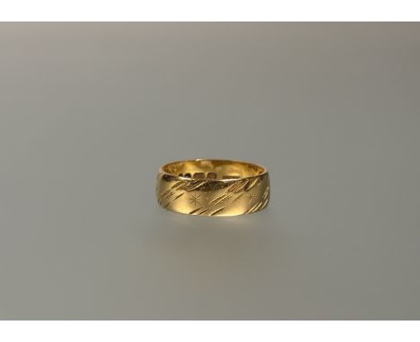 A  22ct gold wedding band with engraved diagonal design and star K/L 4.53g