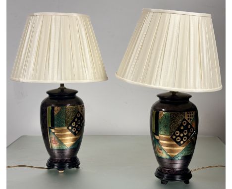 A pair of ceramic baluster table lamps, on purple ground with a geometric abstract design to centre, both raised on a circula
