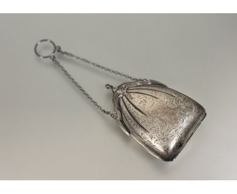 An Edwardian Birmingham silver shaped evening purse with engraved scrolling leaf design and original chain and ring with thre