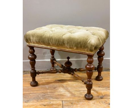 A Victorian walnut stool, with a rectangular button back top on four turned supports united by a cross stretcher with a centr