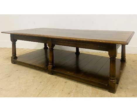 An oak low centre table, with a rectangular moulded top on six turned supports with a panelled shelf below, 47cm 160cm x 80cm