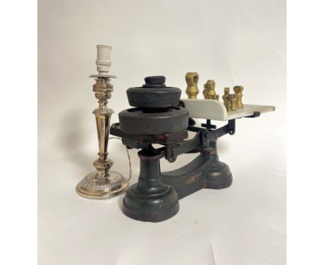 A pair of cast iron scales with a ceramic weighing plate bearing Justice (a/f crack to plate) and various weights including b