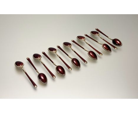 A cased set of twelve Russian silver-gilt and enamel coffee spoons, c. 1900, 84 Zolotnik mark, the handles and reverse of the