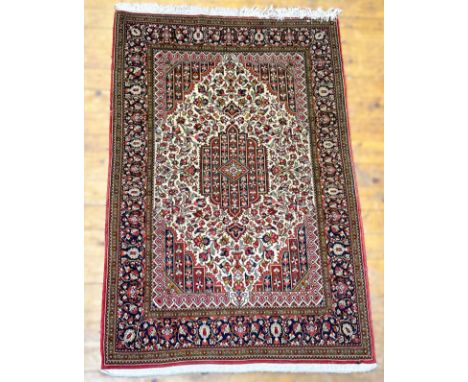 A finely-knotted North-West Persian rug, with shaped centre diamond, trailing floral and leaf design within multiple flowerhe