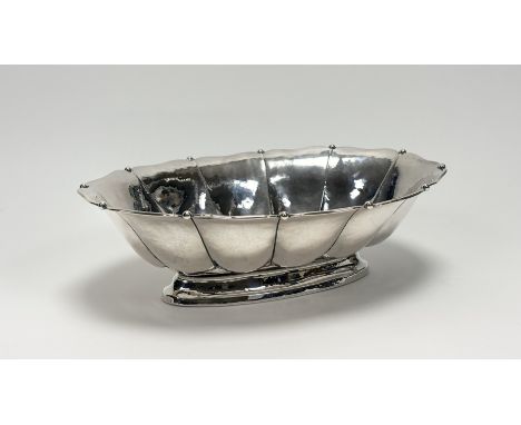 An 830 standard silver centre bowl, probably Scandinavian, planished throughout, of oval lobed form with bead detail to the r