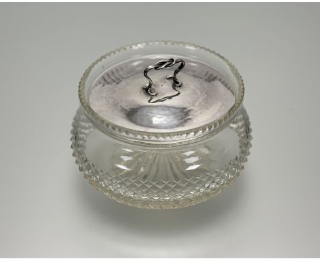 Omar Ramsden &amp; Alwyn Carr, a silver mounted dressing table jar, the cut glass compressed circular jar beneath a planished