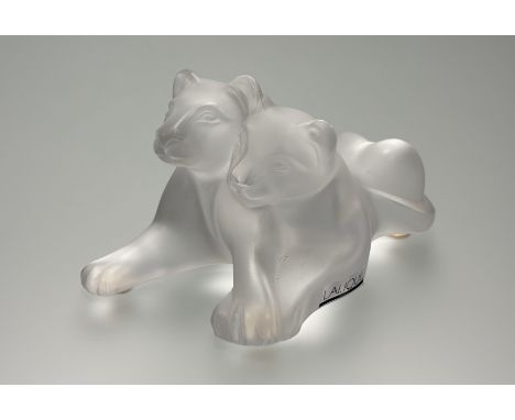 Lalique, a frosted glass "Tambwee" group of two recumbent lion cubs, labels including model no. 11667, engraved mark. Length 