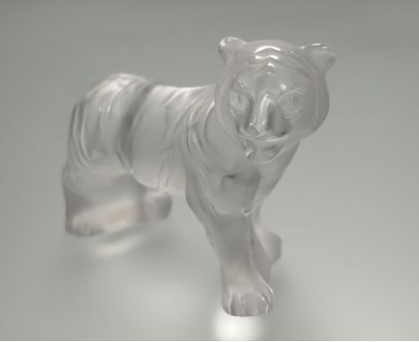 Lalique, a frosted glass model of a standing tiger, labels including model no. 1205500, engraved mark. Length 12cm.