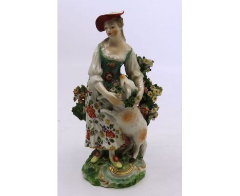 An 18th C Derby figure of a Shepherdess , patch marks to base , 14cm high
Chips to the bocage .
