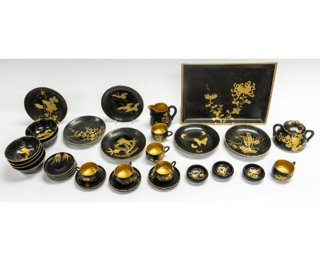 An early 20th century Japanese bakelite teaset, comprising six cups, saucers, side plates, sucrier, tray, gilt decoration