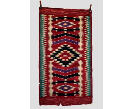Two blankets: the first a Serape/Rio Grande blanket, Mexico, circa 1930s-40s,  6ft. 4in. X 3ft. 6in. 1.93m. X 1.07m. 'Bite' t