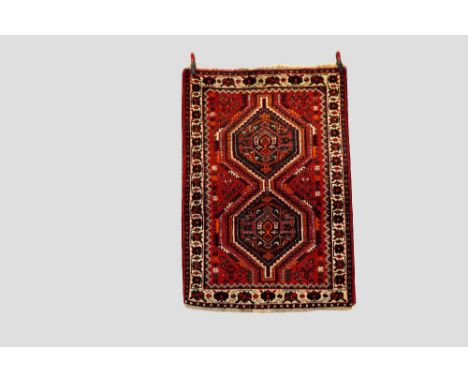 Two rugs: the first a Fars rug, Shiraz area, south Persia, mid-20th century, 4ft. 11in. X 3ft. 6in. 1.50m. X 1.07m. Red field